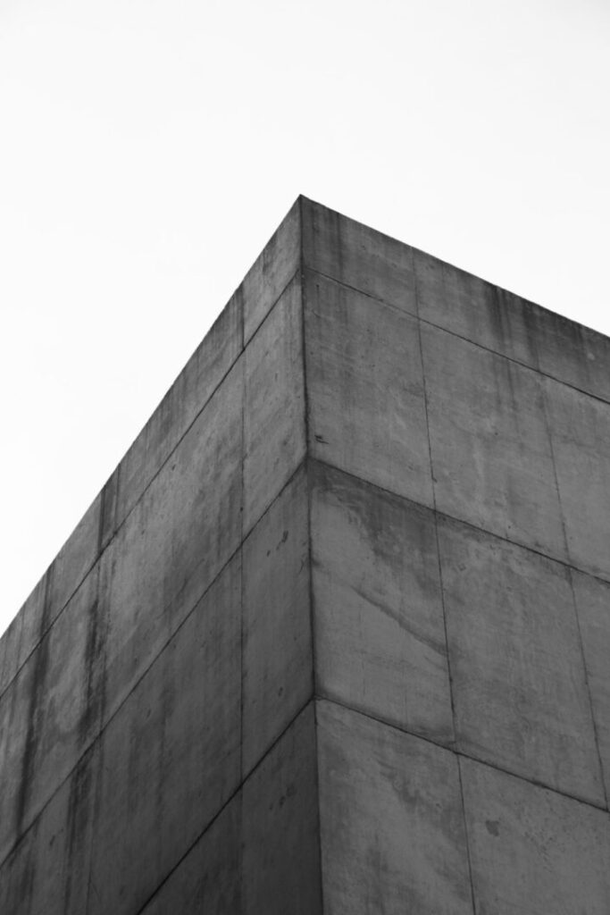 Concrete building corner against a white sky