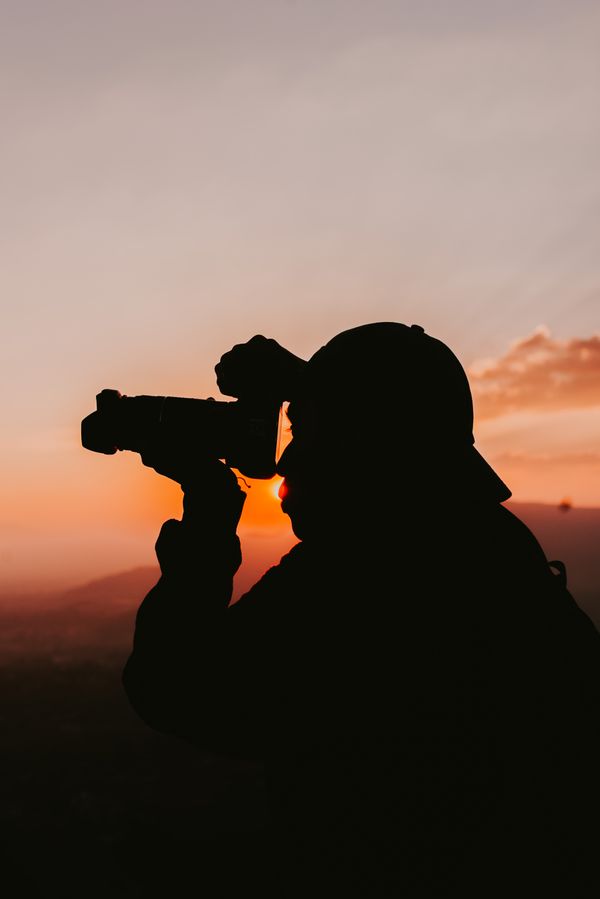 Photographer silhouetted at sunset